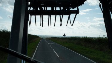 View of a road from the cab of a tractor
