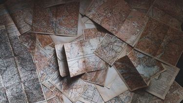 A picture of maps scattered across a table
