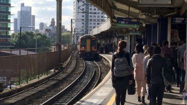 Busy platform with train departing