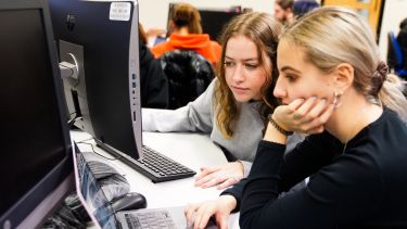 Two students looking at a computer