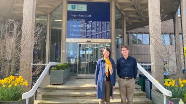 Dr Wei Yang and Professor David Robinson stand in front of the Geography and Planning Building