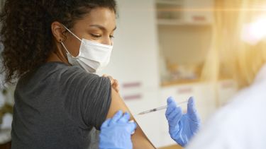 A photo of a woman being vaccinated