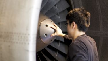 Engineering student looking at jet engine