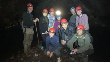 Group in tunnel surrounded by water