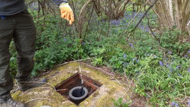 Water sampling taken from a borehole in the ground at our field site in Harpenden