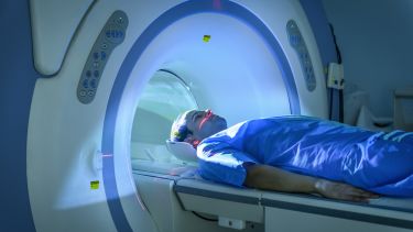 Male patient entering Magnetic Resonance Imaging (MRI) scanner
