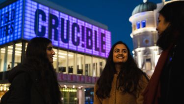 Three students stood talking outside crucible theatre
