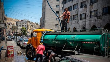 A tanker delivers drinking water to city residents