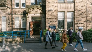 A group of politics students walking in front of the Elmfield building at the University of Sheffield.