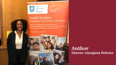 author Simone Atangana Bekono next to a banner about Dutch Studies during her visit to Sheffield