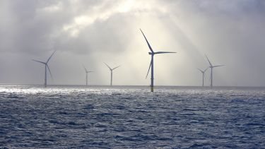 An offshore wind farm seen on a cloudy and windy day