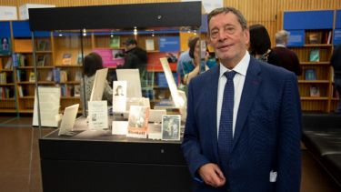 David Blunkett standing in front of an exhibition 