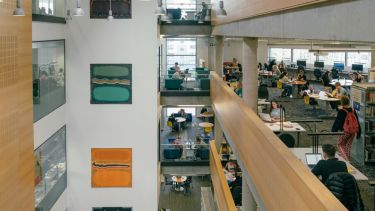 An image of the inside of the Information Commons, comprising multiple levels of the building, with students studying