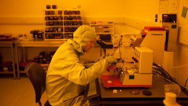 Image of student in clean room working on project