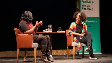 Two women having a discussion on stage as part of a previous event at Off The Shelf