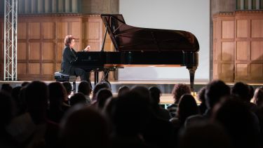 piano performance on stage with audience
