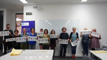 Students present their calligraphy after class