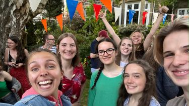 Group of students smiling and cheering