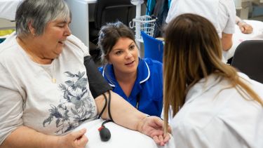 Student nurse talking to a patient.