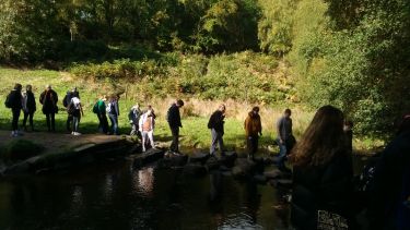 group of walkers on stepping stones 