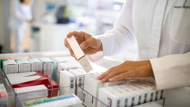 Pharmacist looks through medications 