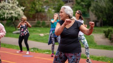 Older woman in park exercising
