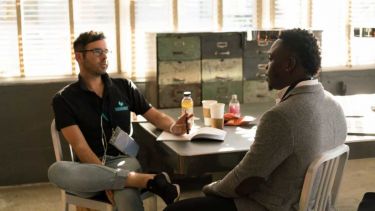 Two people talking at table