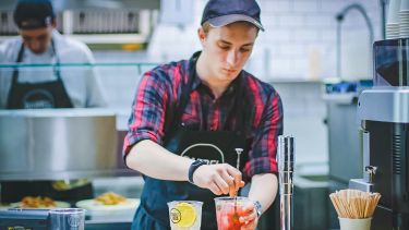 A young adult working in hospitality.