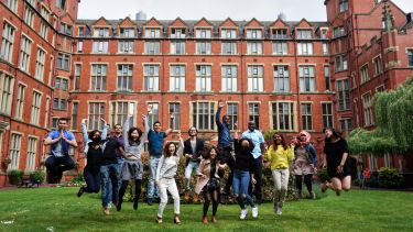 International student ambassadors pictured jumping cheerfully outside Firth Court.