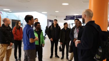 An Engineering student ambassador gives visiting industry employers a tour of the university's facilities