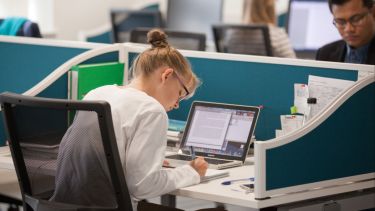 A photo of a Postgrad researcher in a study space