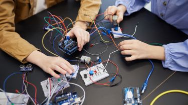 Young people operating circuitry