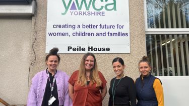 A group of women stand outside YWCA Yorkshire, Peile house.