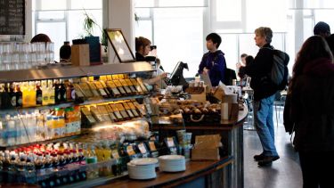 Image of sandwiches and people in a cafe