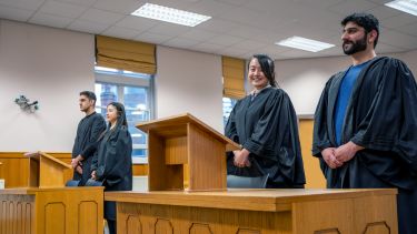 Two pairs of students competing in a mock trial within the Moot Court 
