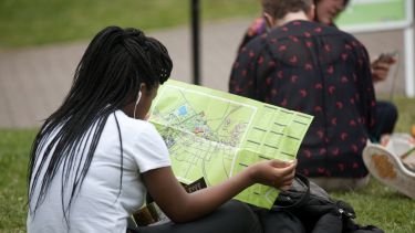A girl looks at a map of campus