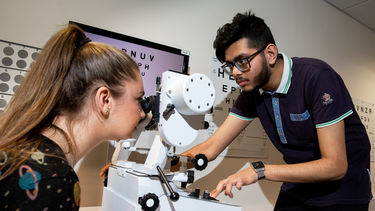 Orthoptics student giving an eye test to a patient