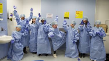 Children dress up in scrubs as part of Children's University - Project in a Box Year of the Doctor