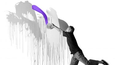 man throwing paint over wall
