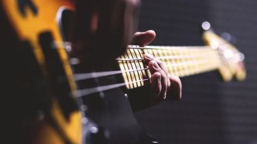 An image of an electric guitar, taken as someone is holding it