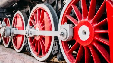Red wheels of a train from a picturesque angle