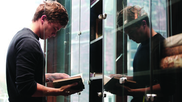 A researcher consulting a book in a library