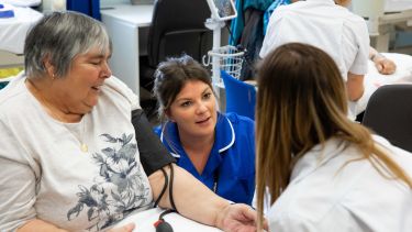 Student nurse talking to a patient