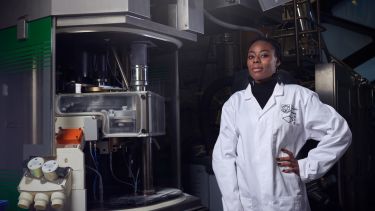 A person in a lab coat in the Diamond Pilot Plant