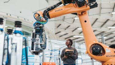 Nandi Moyo, an apprentice at Boeing using a robotic arm at the AMRC Training Centre
