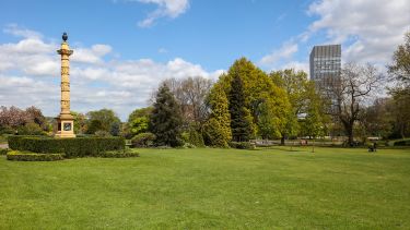 A green lawn area of Weston Park with the Arts Tower in the background