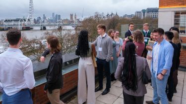 Photograph taking of attendees networking on the balcony at the IET Future Talent Awards