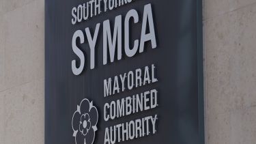 Photo of SYMCA logo sign on a wall