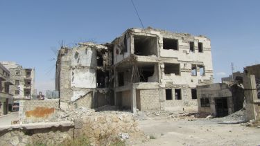 The remains of a building damaged by the civil war in Syria