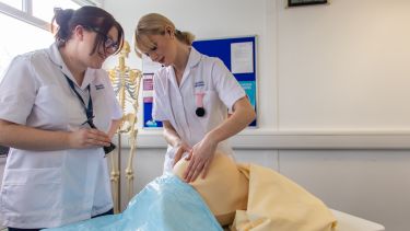 Two student midwives testing their clinical skills